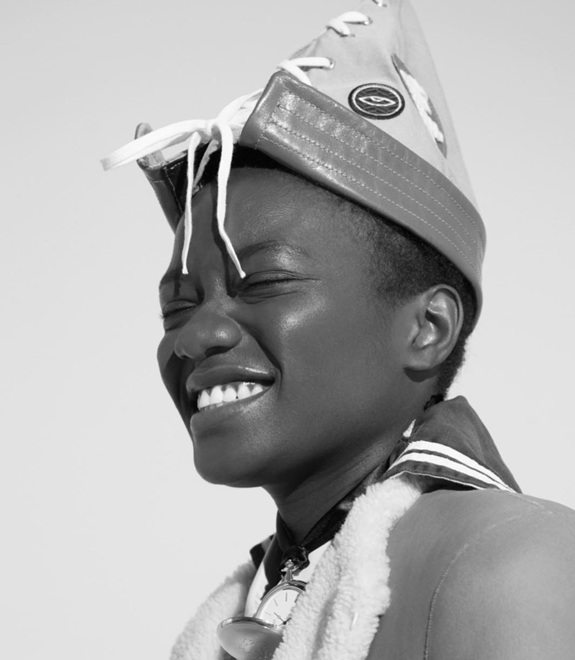 Black and white studio portrait, headpiece and shearling coat